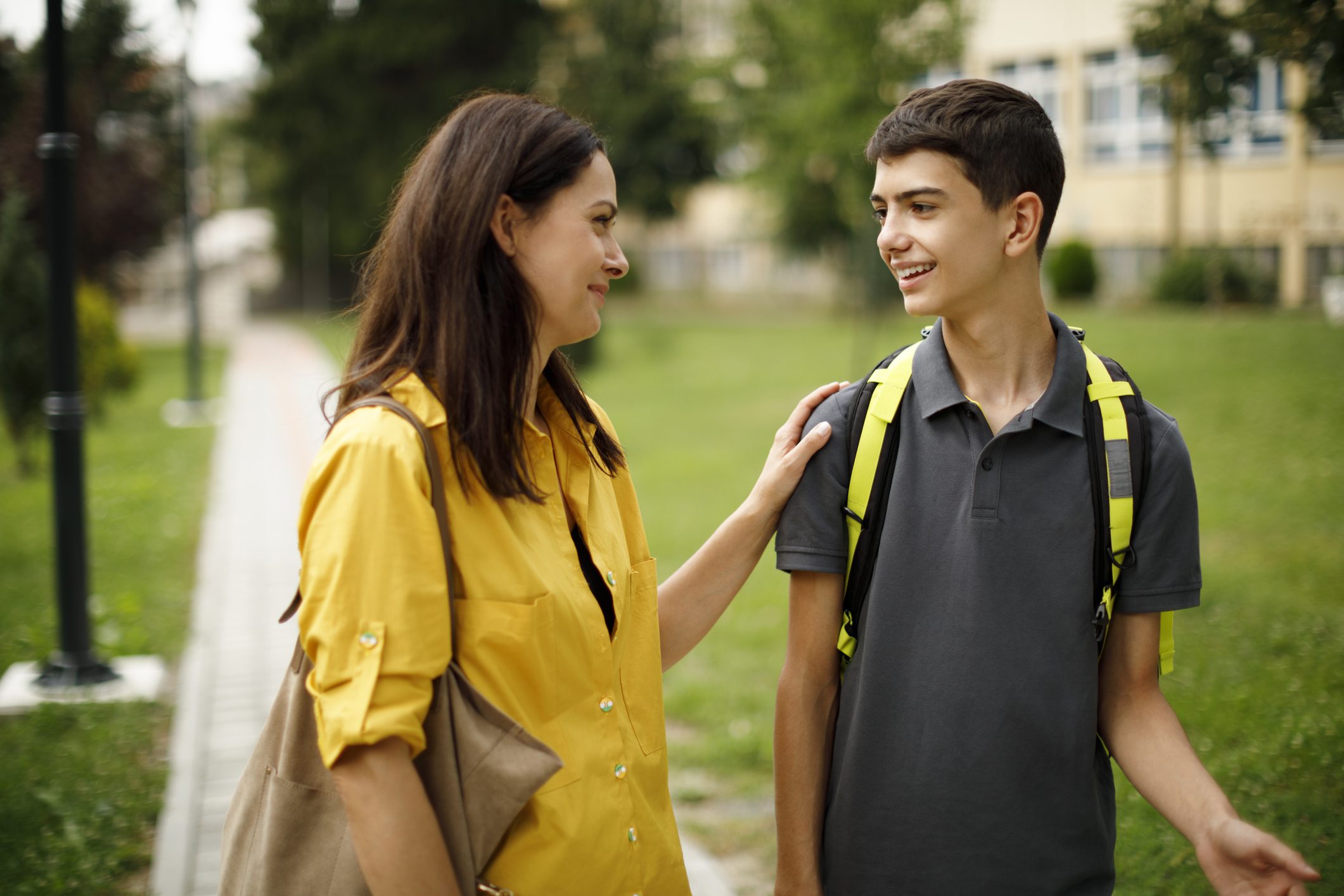 A mother drops off her teen son at school
