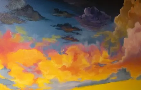 Painting of a brightly colored clouds as a sunset is happening