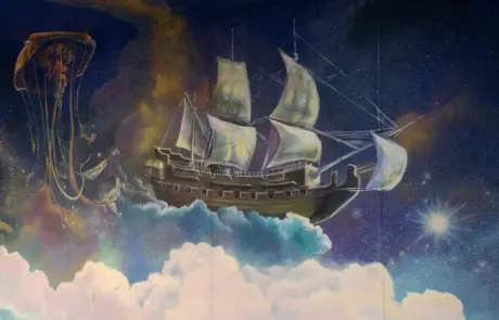 Painting of an etherial rigged sailing ship flying in clouds amongst larger-than-life jellyfish.