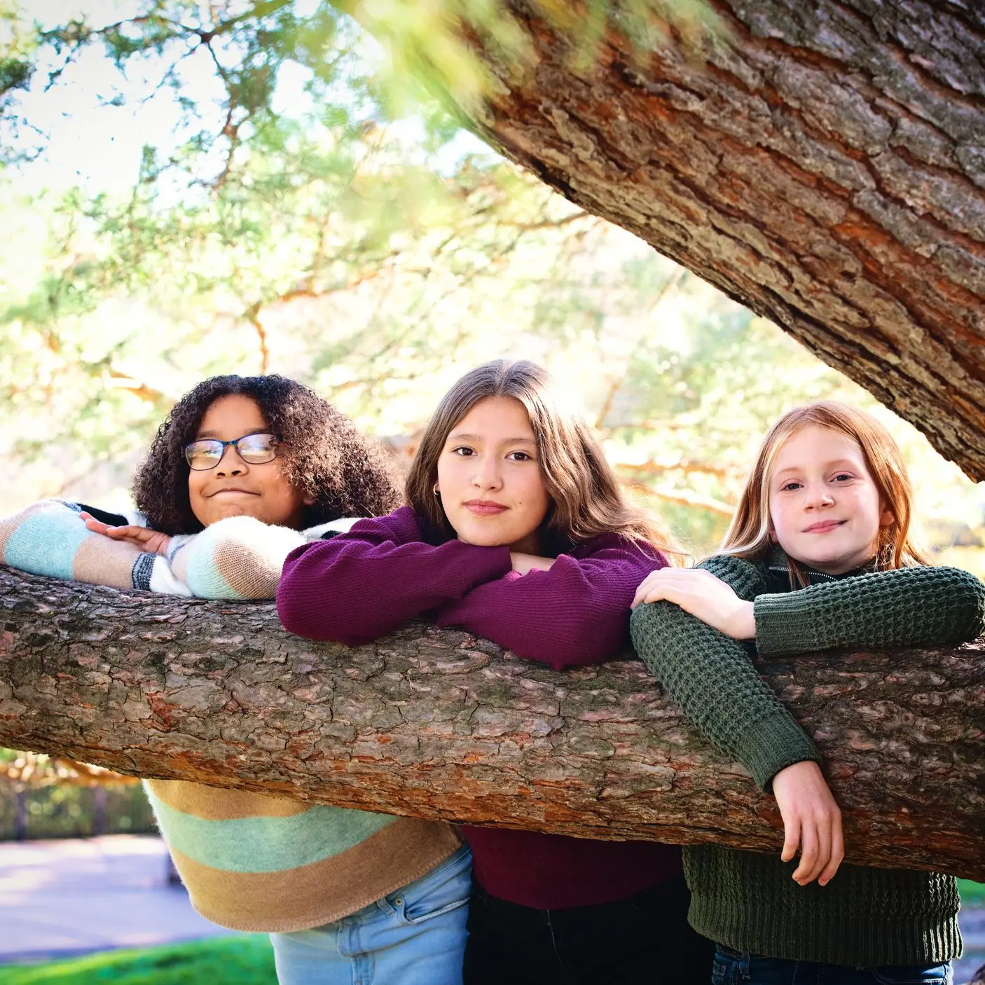 young girls hanging out on tree