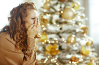 Upset Woman near a Christmas tree.
